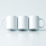 Three blank glossy white ceramic mugs with curved handles displayed on a clean studio background.