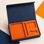 Open navy gift box with an orange fitted insert.