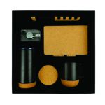 Top view of a black-and-cork executive gift set containing a notebook, pen, bottle, mug, coaster and keychain in a fitted presentation box.
