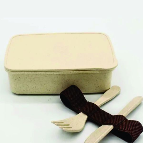 Closed beige wheat-straw lunch box displayed with matching fork, knife and textured brown elastic retaining strap.