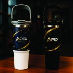 White and black 30oz double-wall stainless-steel travel tumblers with raised folding carrying handles.