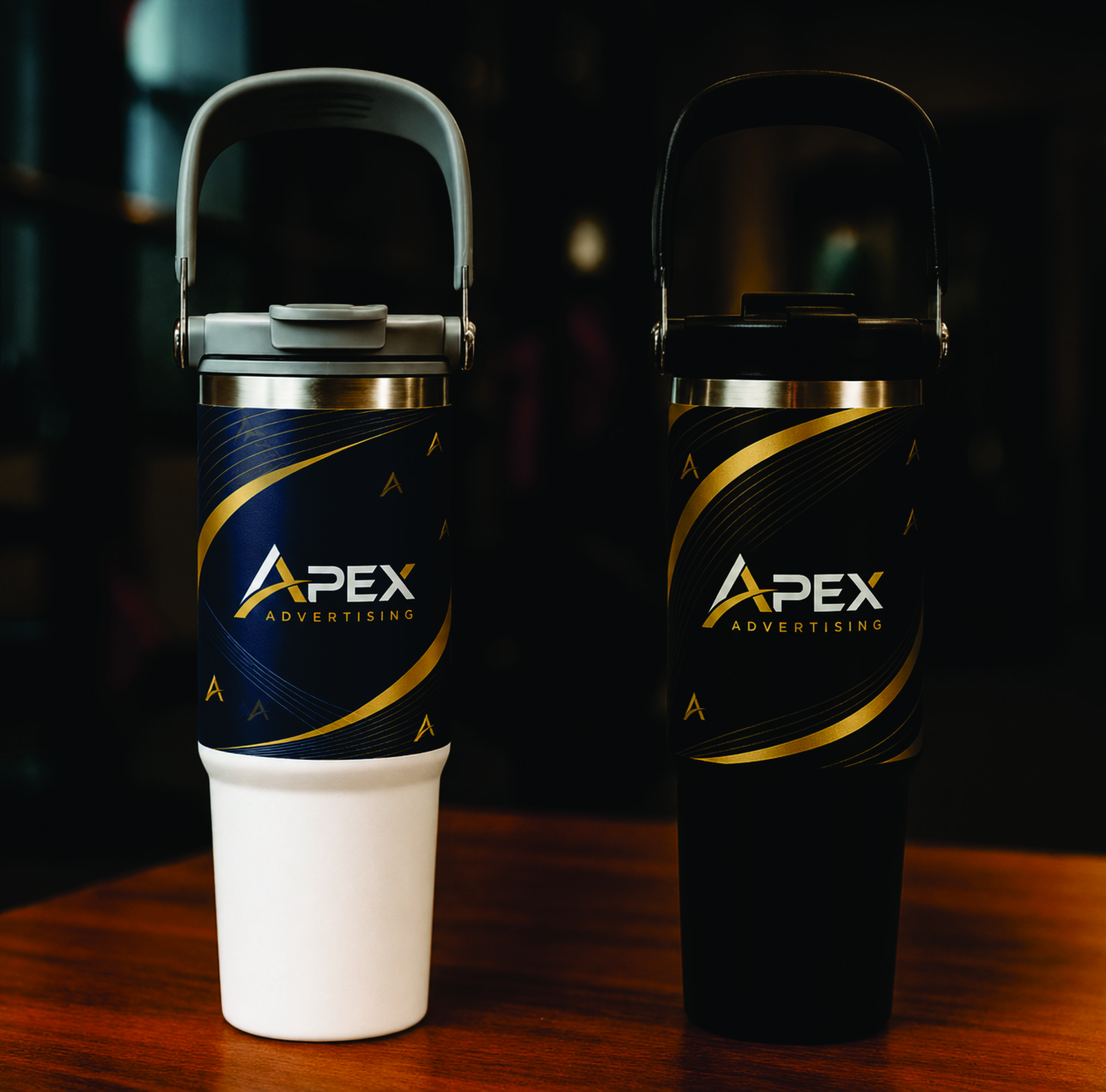 Tumbler White and black 30oz double-wall stainless-steel travel tumblers with raised folding carrying handles.
