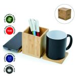 Bamboo pen holder with side platforms labelled as a wireless charging pad and mug warmer pad.