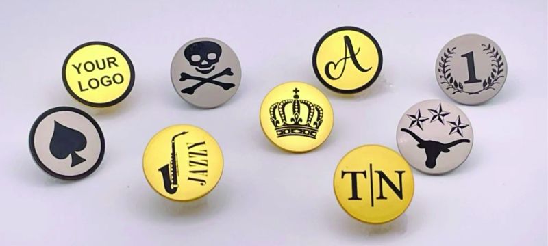 Collection of customized enamel lapel pins displayed in different shapes, colours and finishes.